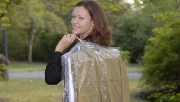 woman carrying dry cleaning
